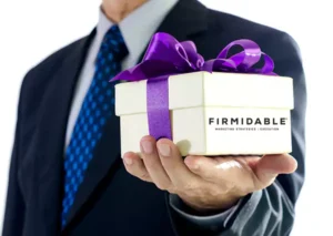 Someone handing out a wrapped gift box with the Firmidable logo on it.